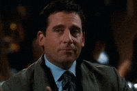 GIF of Steve Carrell winking whilst raising a class.