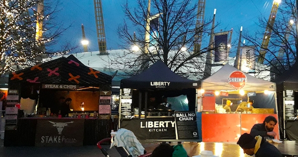 Three food stalls outside the O2, the middle one is called Liberty Kitchen and Is black
