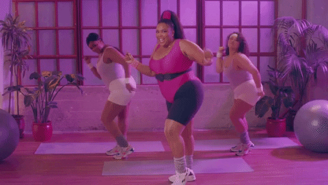Lizzo and backup dancers in 80s fitness gear dancing