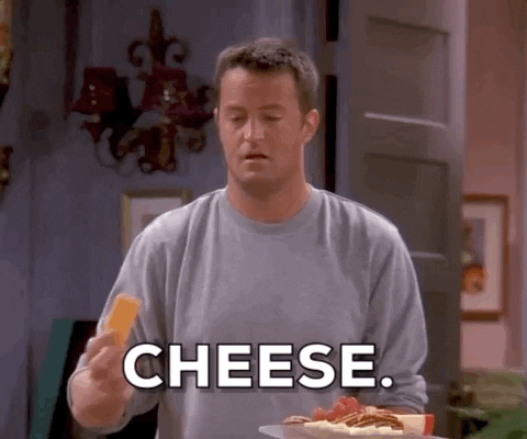 GIF of Chandler from Friends, saying 'cheese, it's milk that you can chew'